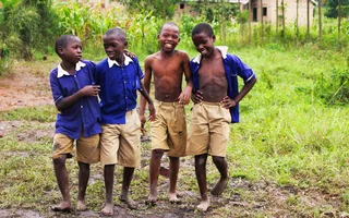 Schoolchildren in uniform smiling together in Uganda
