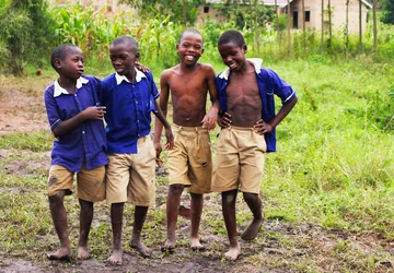 Schoolchildren in uniform smiling together in Uganda