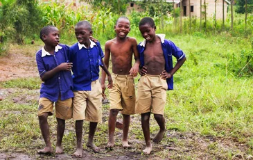 Schoolchildren in uniform smiling together in Uganda