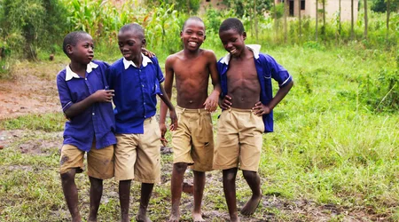Schoolchildren in uniform smiling together in Uganda