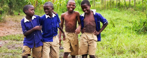 Schoolchildren in uniform smiling together in Uganda