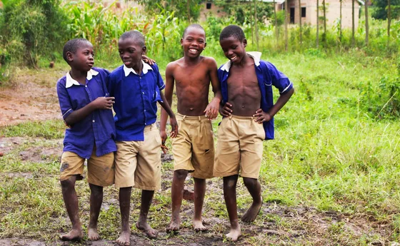 Schoolchildren in uniform smiling together in Uganda