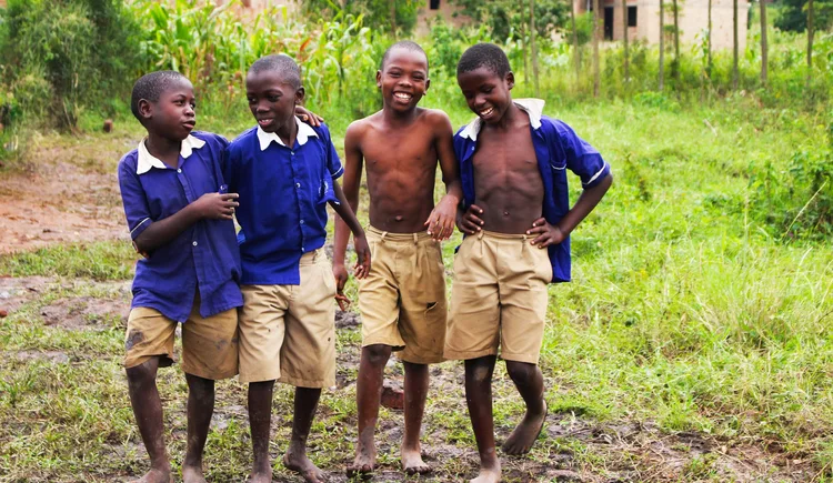 Schoolchildren in uniform smiling together in Uganda
