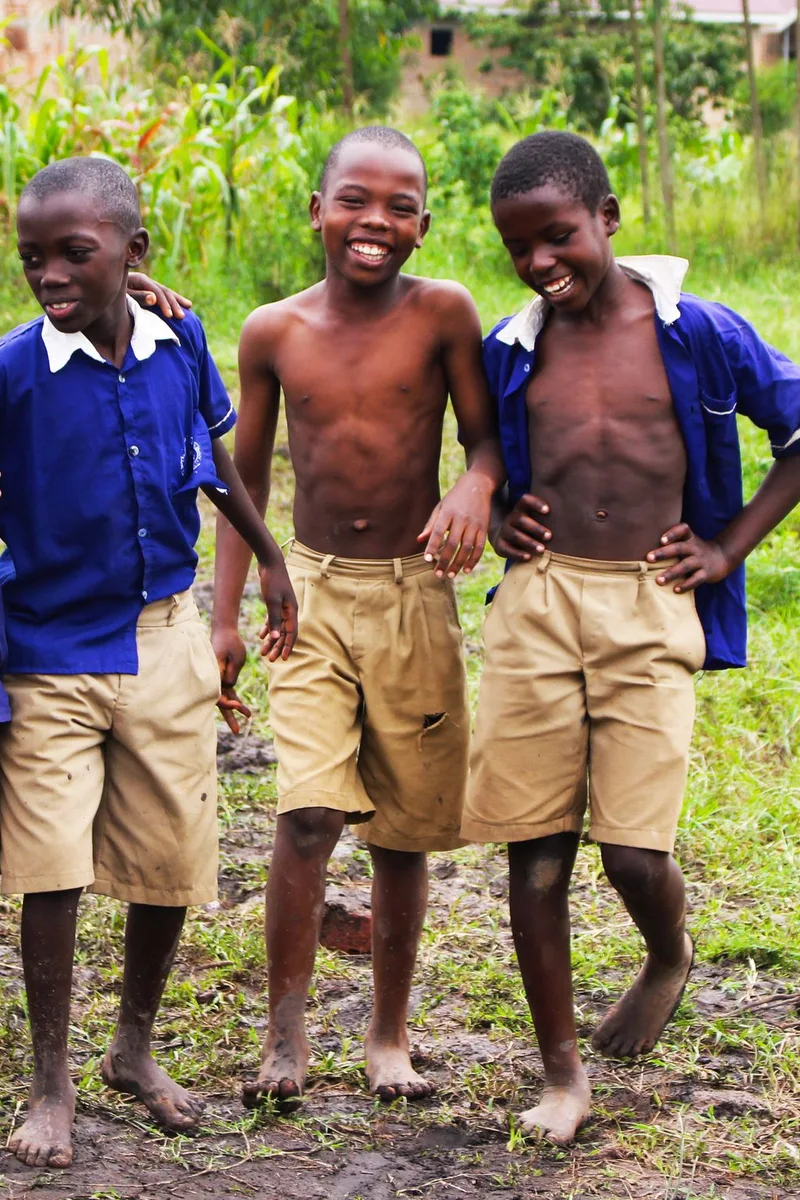 Schoolchildren in uniform smiling together in Uganda